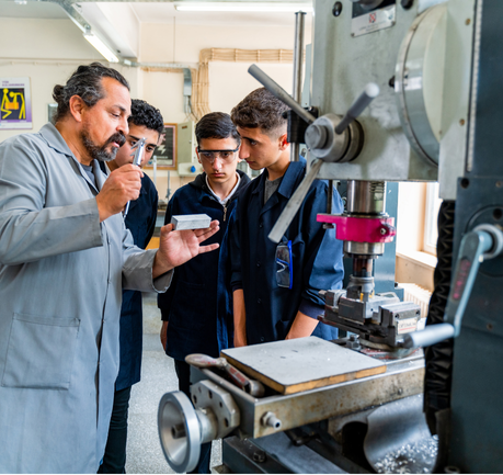 Group of young people in technical vocational training with teacher